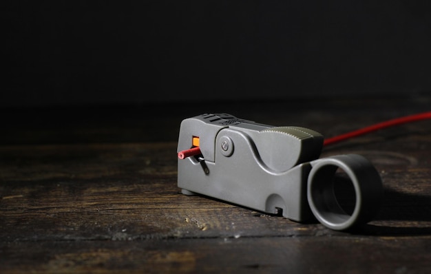 Photo coaxial cable stripper or cable cutter on wooden background