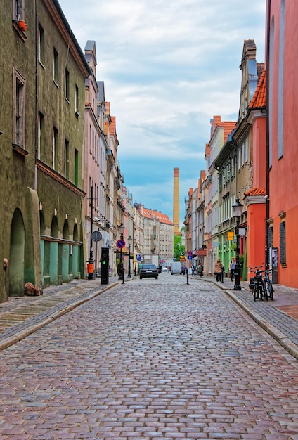 Cobblestone street of the Old town of Poznan, Poland. People on the background