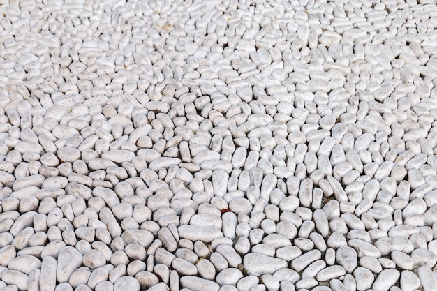 Cobblestones. Large white stones on the road. Round white boulders on road. 