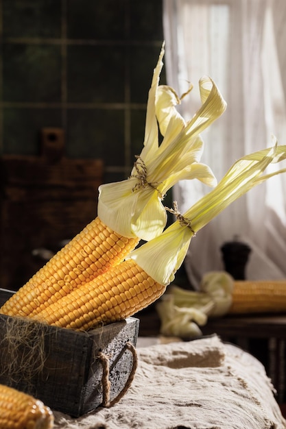 Photo cobs of sweet golden corn in a wooden box