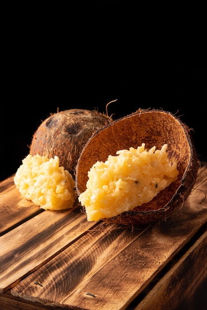 Cocada Brazilian coconutbased candy arranged on a rustic wooden table selective focus