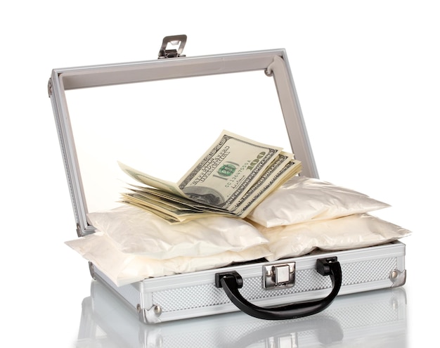 Photo cocaine with money in a suitcase isolated on white