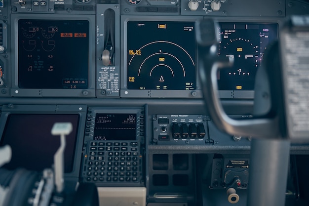 Cockpit of passenger airplane with flight instruments, displays and navigational systems