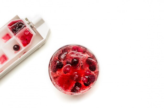 Cocktail of berries frozen in ice cubes 