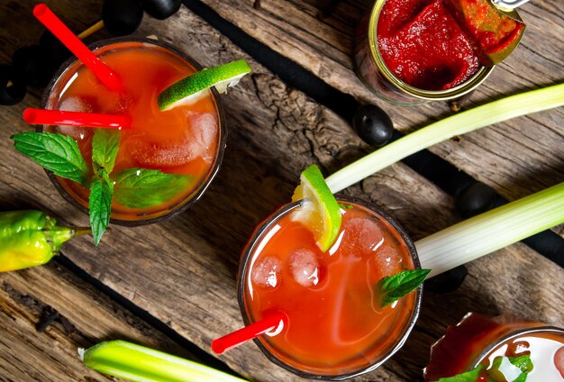 The cocktail bloody mary . Making cocktail with ingredients on wooden background . Top view