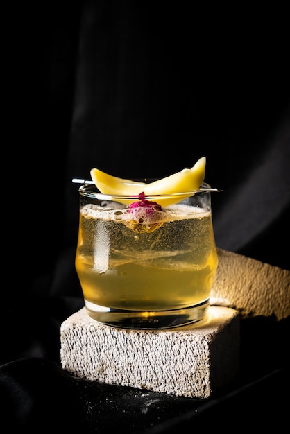 cocktail bourbon homemade pickle mango and star gooseberry orange bitter sparking wine lime juice in glass on dark background