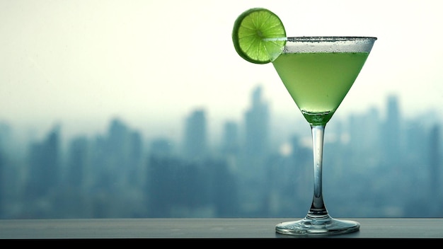 Cocktail on counter bar blur cityscape background.