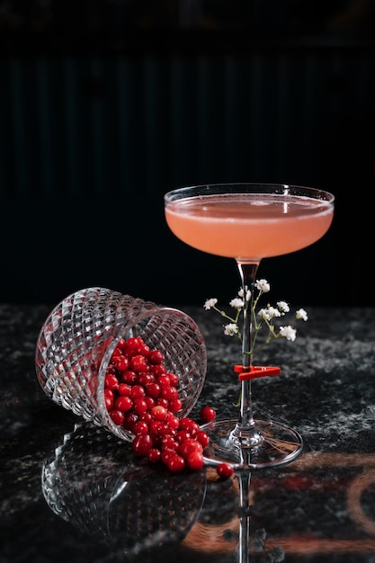 Cocktail decorated with berries on the bar