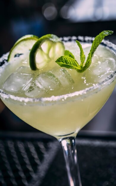Cocktail drink frozen margarita at barcounter in night club or restaurant