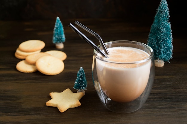 Photo cocktail eggnog and cookies are the stars on the background lights.