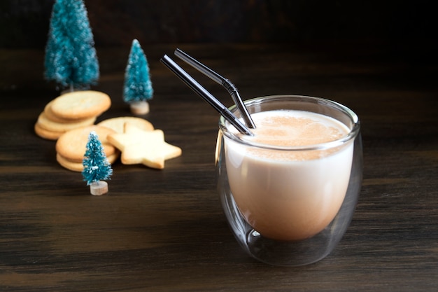 Cocktail eggnog and cookies are the stars on the background lights.