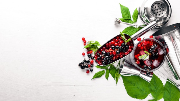 Cocktail of fresh red currant with ice on a wooden background Top view Free space