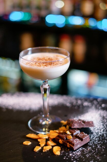 Cocktail garnished with dried chocolate on the bar counter The concept of the correct preparation of drinks