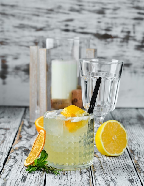 Cocktail Gin tonic with citrus in a glass On a wooden background Top view Free copy space