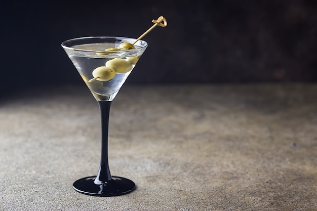 Cocktail martini with olives on stone