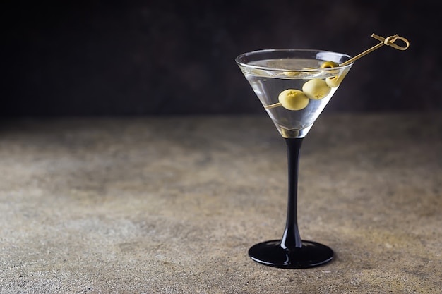 Cocktail martini with olives on stone