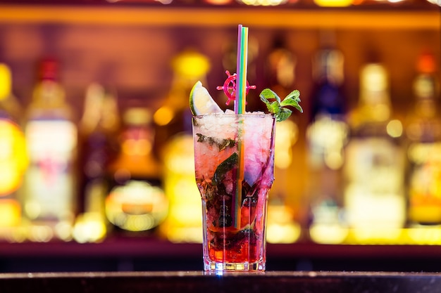 Cocktail Mojito with strawberry liqueur in a glass on bright lights. The national drink of Cuba.