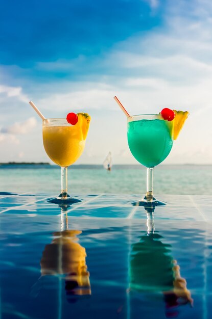 Cocktail near the swimming pool on the background of the Indian Ocean, Maldives.