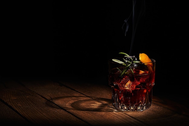 Cocktail Negroni on dark wooden board