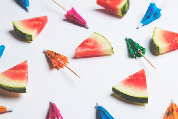 Cocktail umbrella and watermelon summertime background