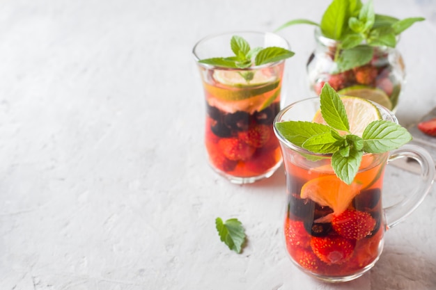 Cocktail with black currant, strawberry, mint and lime. Cooling summer drink.