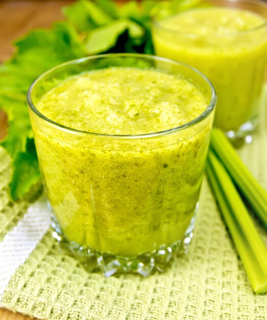 Cocktail with celery on napkin and board