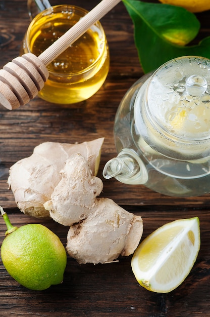 Cocktail with ginger, lemon and honey on the wooden table