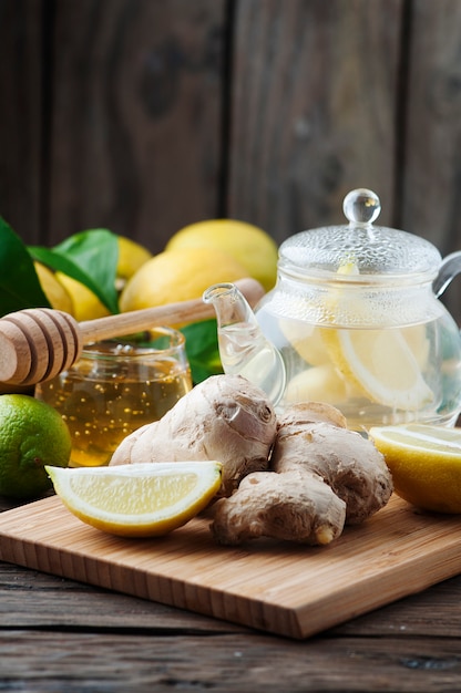 Cocktail with ginger, lemon and honey on the wooden table