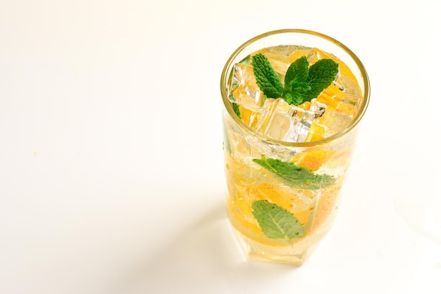 Cocktail with lemon and mint on a white background Copy space