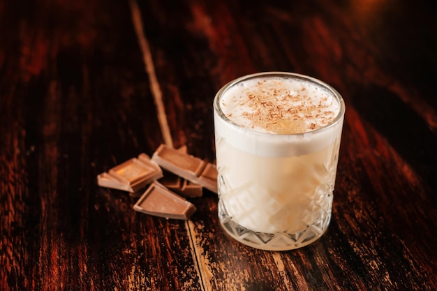 Cocktail with milk and chocolate on wooden table