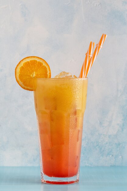 Cocktail with orange juice and ice cubes