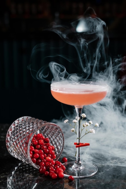 Cocktail with red berries and smoke