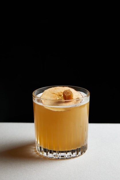 Cocktail with whiskey dried apple slice and sugar