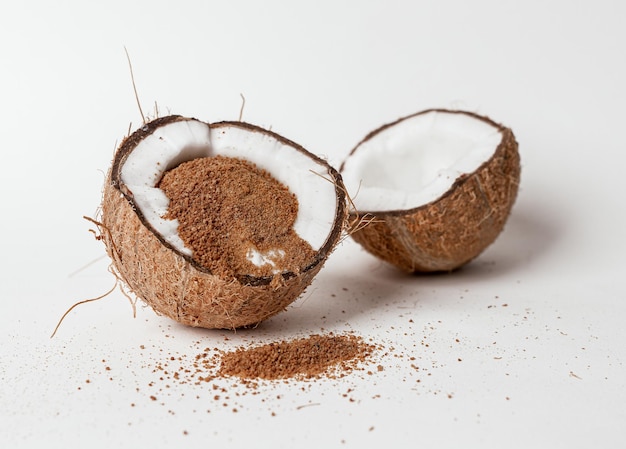 Coco nut sugar brown organic natural sweet ingredient inside cracked cut coco nut fruit half