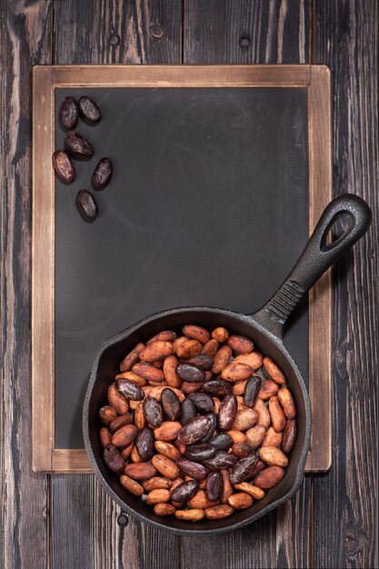 Cocoa beans in pan and chalk board