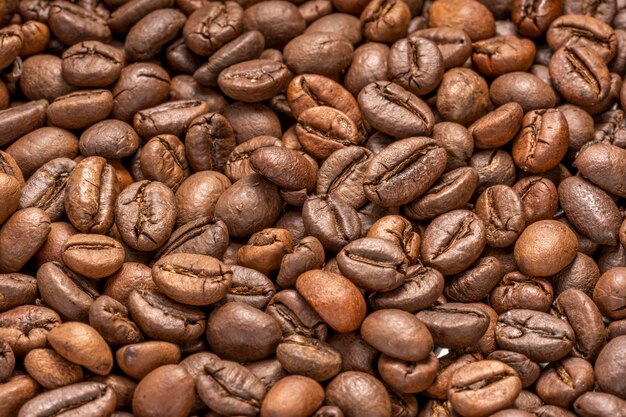 Cocoa beans on wooden plate, Aromatic, Roasted Cocoa beans in wooden background.