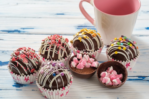 Cocoa bombs are black chocolate shells filled with cocoa powder and marshmallows