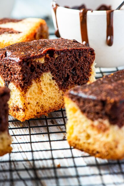 Cocoa and chocolate marble cake on cooling tray on wooden table