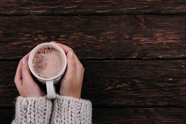 cocoa in the hands on a wooden background