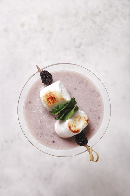 Cocoa latte marshmallow and BlackBerry. Milkshake with berries.