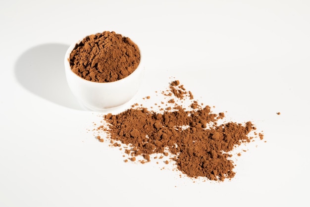 Cocoa powder in white bowl n white background