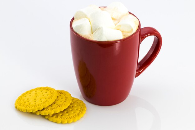 Cocoa in Red mug with Marshmallows and biscuits, isolated on white background