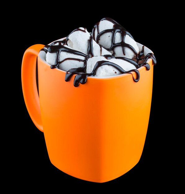 Cocoa with marshmallow and chocolate syrup in a Cup on a dark background