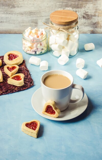 Cocoa with marshmallows and a cookie heart. Selective focus.