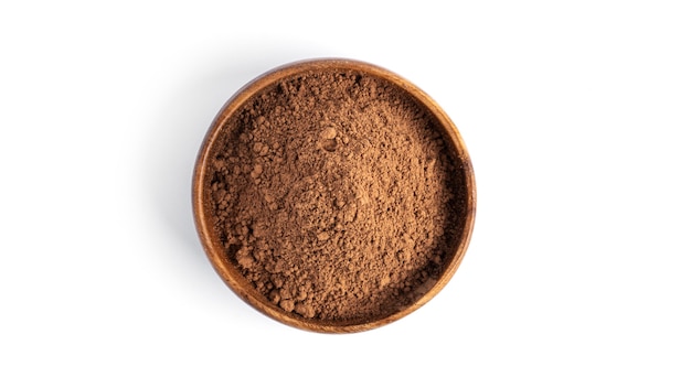 Cocoa in wooden bowl isolated on a white surface