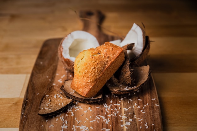 A coconut cake on wooden board