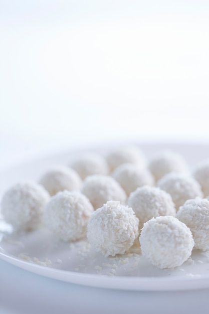 Coconut cakes light dessert in the form of balls on a light background