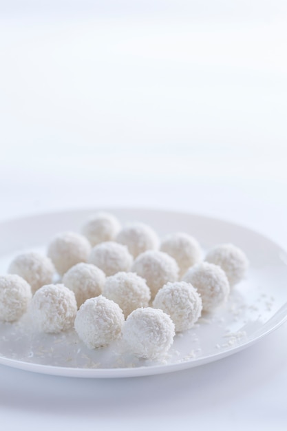 Coconut cakes light dessert in the form of balls on a light background