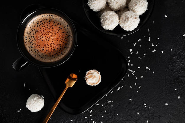 Coconut candies with nuts on dark background Raffaello on black background High quality photo