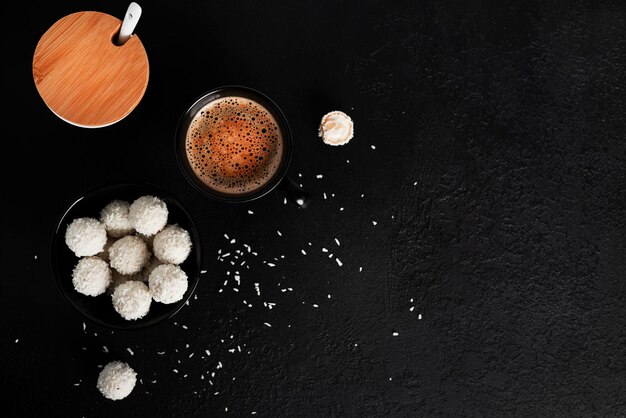 Coconut candies with nuts on dark background Raffaello on black background High quality photo